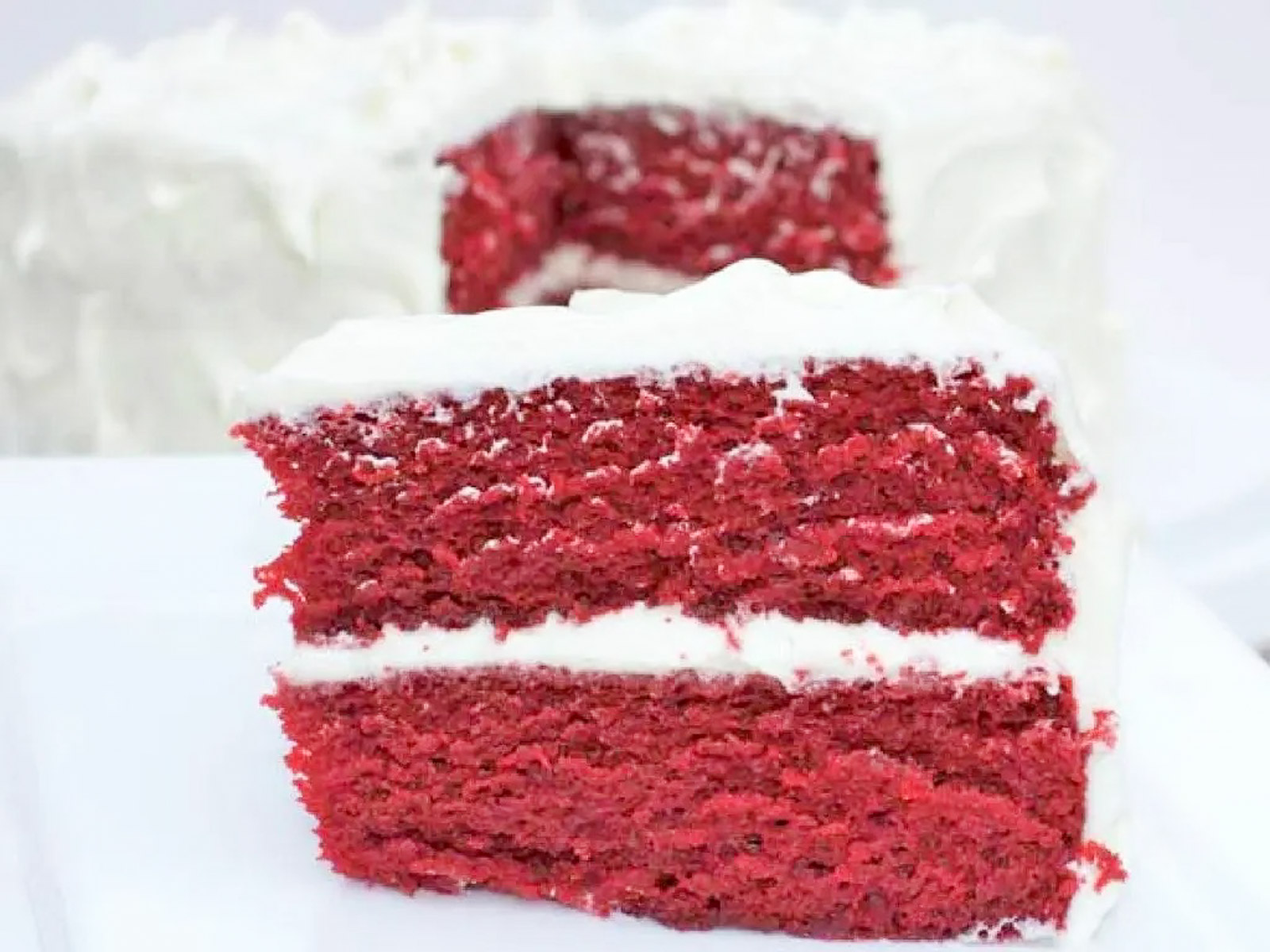 Homemade red velvet cake slice showing soft fluffy red crumb