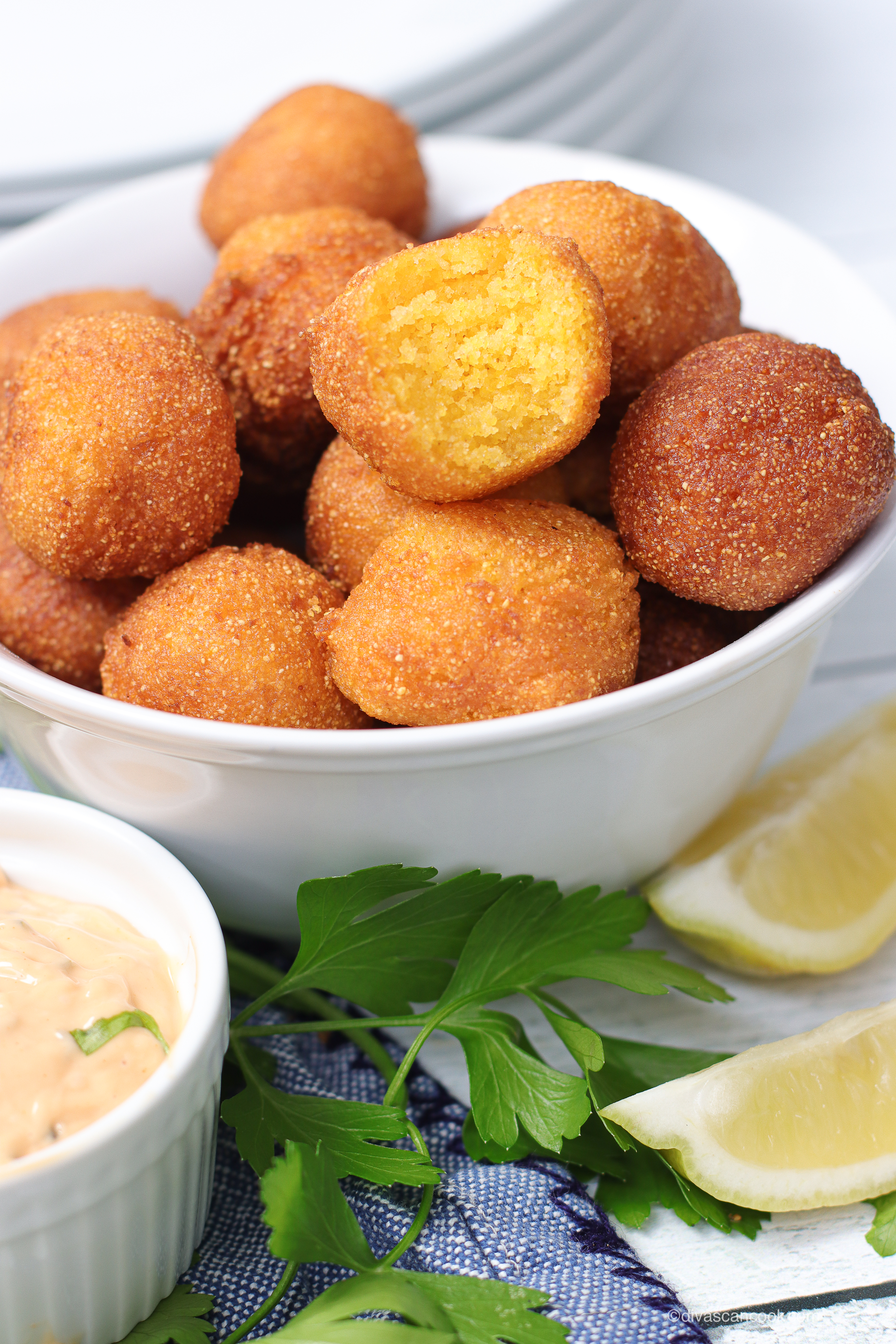Bowl of crispy homemade hush puppies with dipping sauce