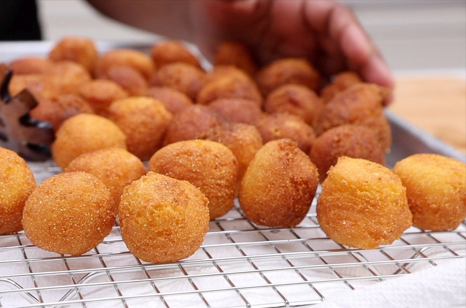 Golden brown homemade hush puppies fresh from the fryer
