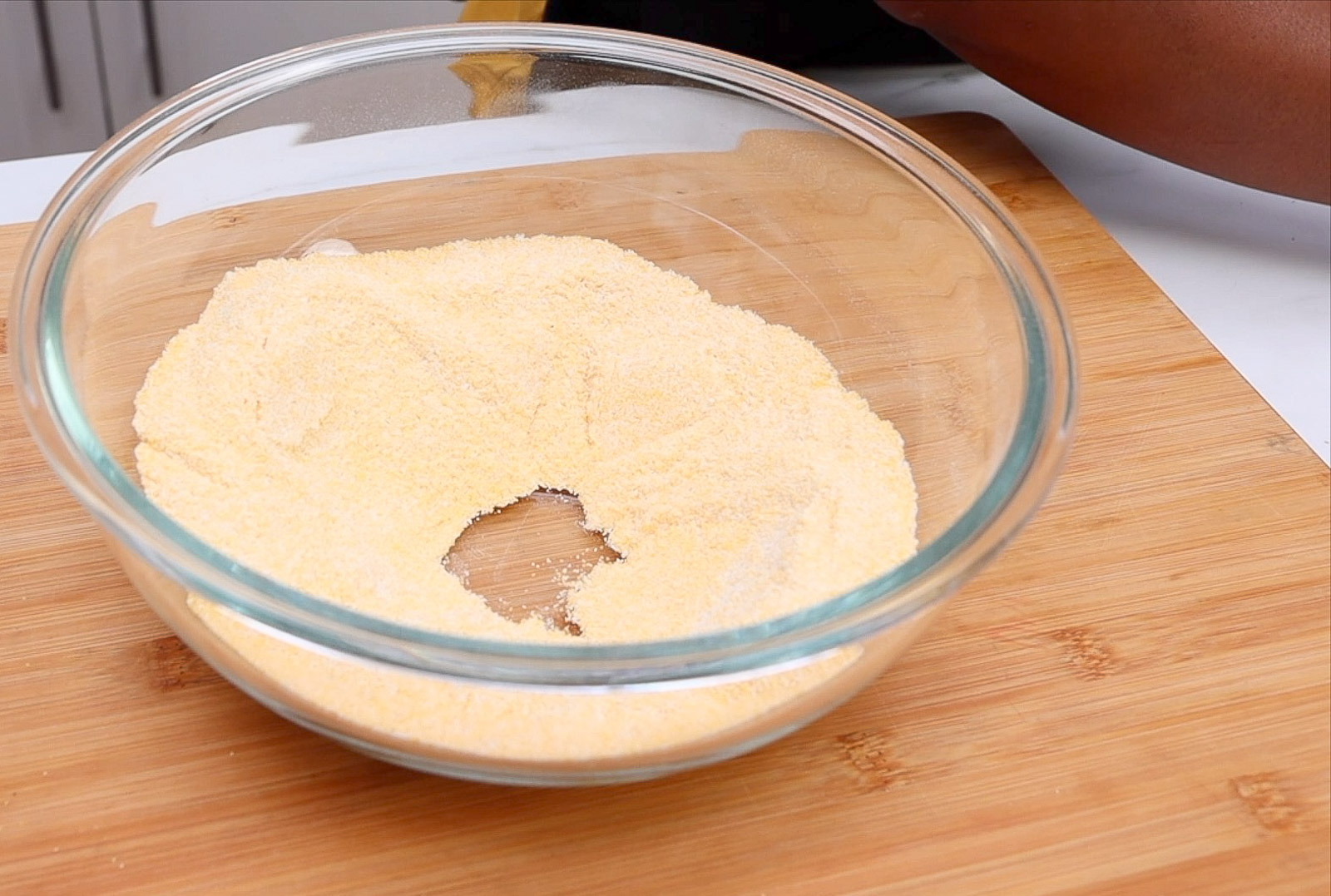 Sifting dry hush puppies ingredients.