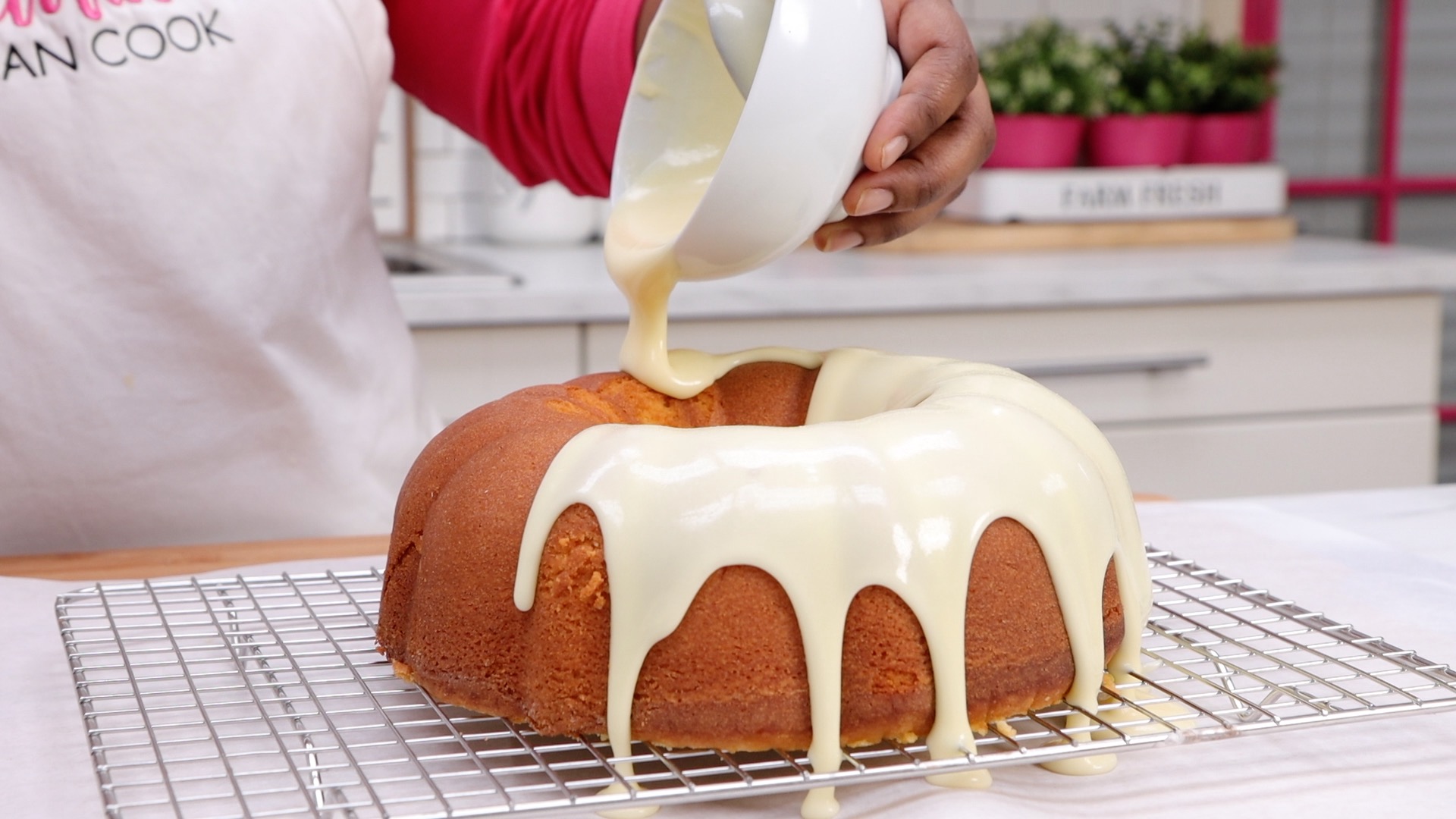 drizzling lemon glaze on pound cake