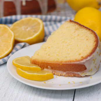 A slice of lemon pound cake on a place with lemon glaze