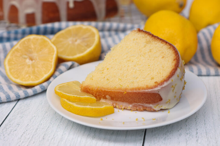 A slice of lemon pound cake on a place with lemon glaze