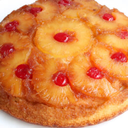 Close up of whole pineapple upside down cake showing caramelized pineapple topping.