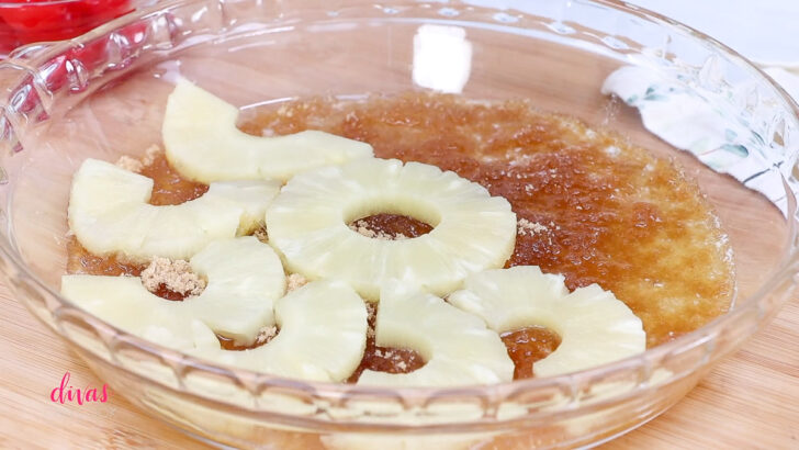 Adding pineapple rings to the topping of pineapple upside-down cake