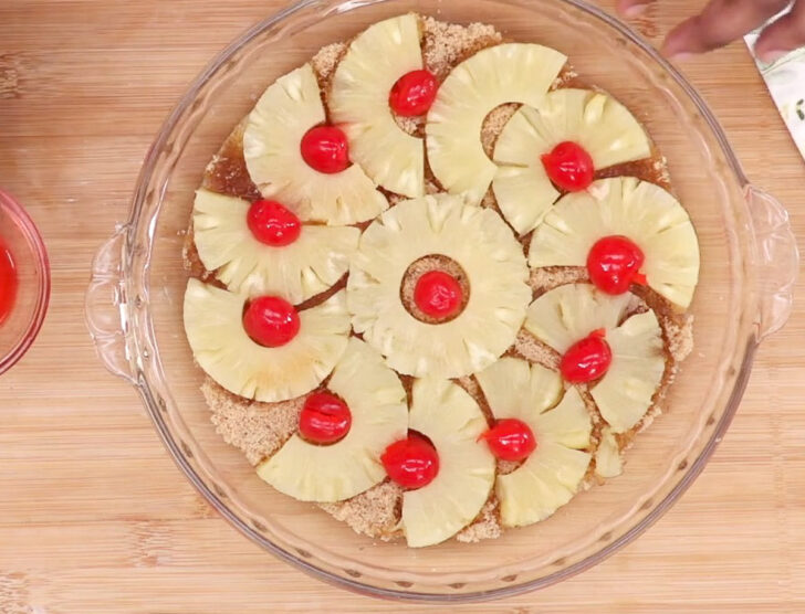 Arranging the cherries on pineapple upside down cake