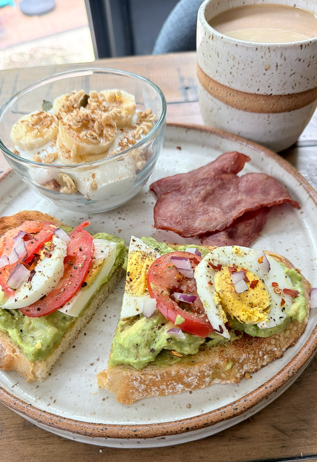 Healthy breakfast menu of avocado toast, parfait, and turkey bacon.