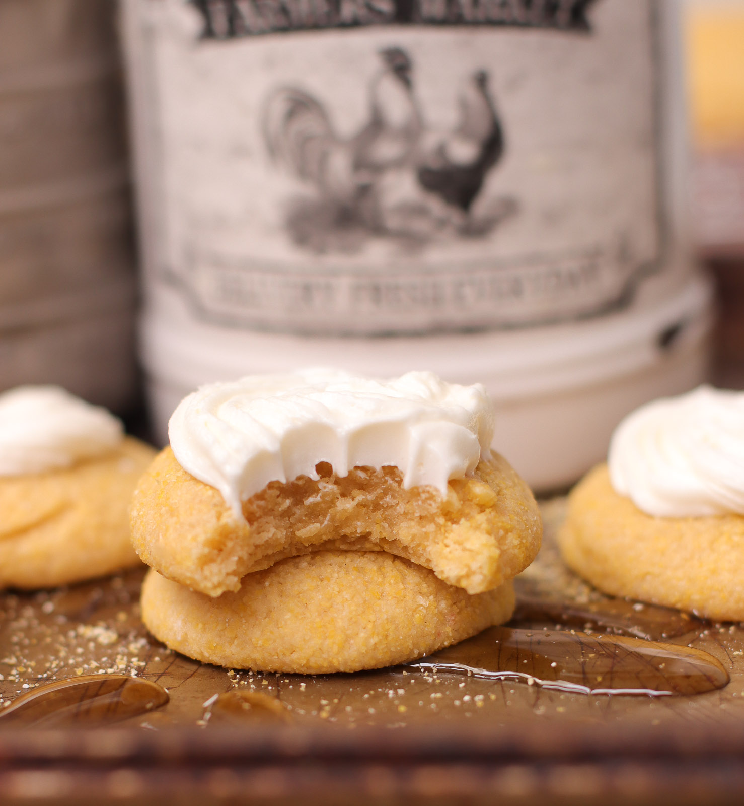 closeup of crumbl cornbread cookies with whipped honey buttercream frosting